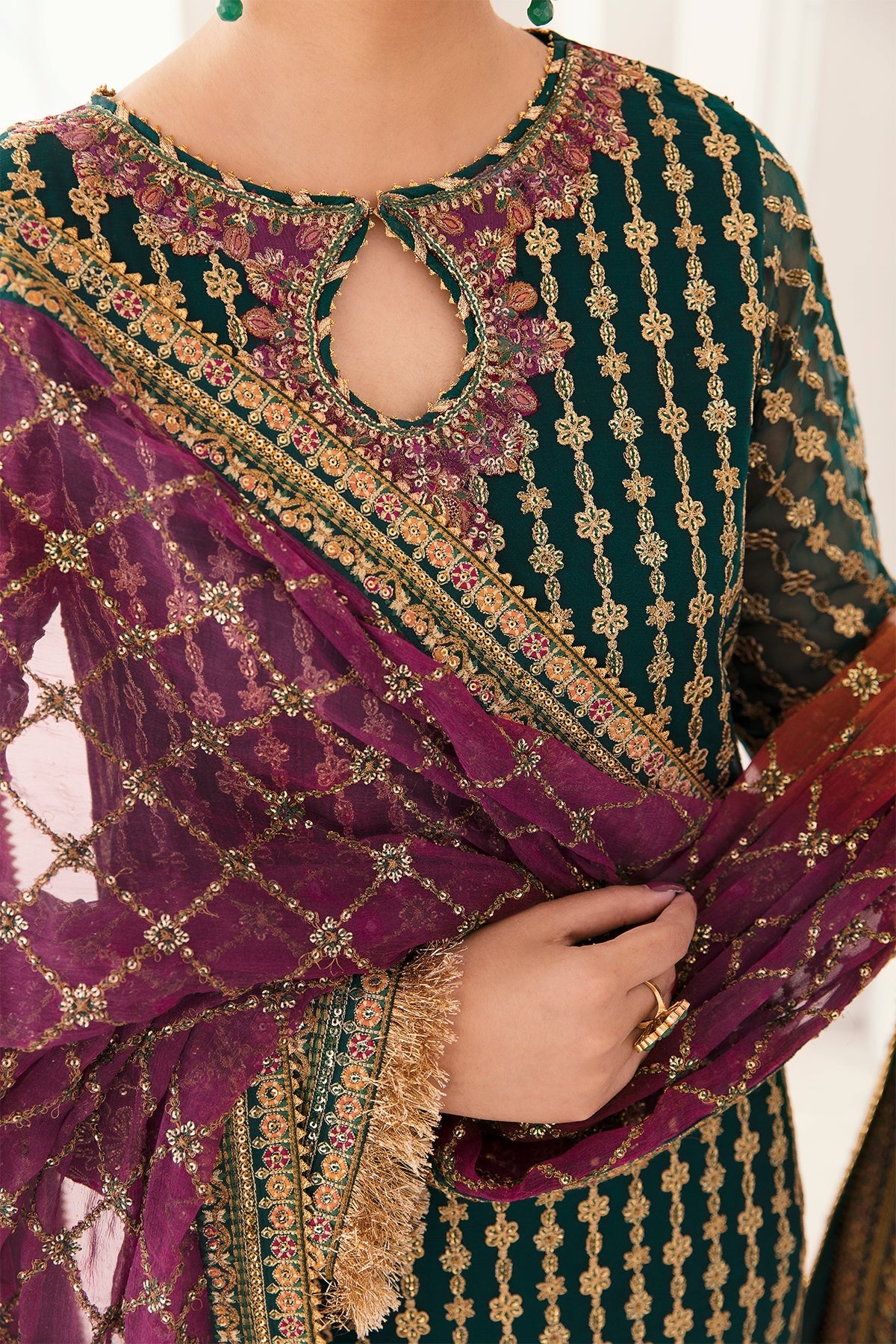 Traditional embroidered outfit with a focus on intricate patterns and colors.